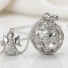 Collana Chiama Angeli in argento con ciondolo a sfera traforata con stelle e angelo con tromba incastonato di brillanti